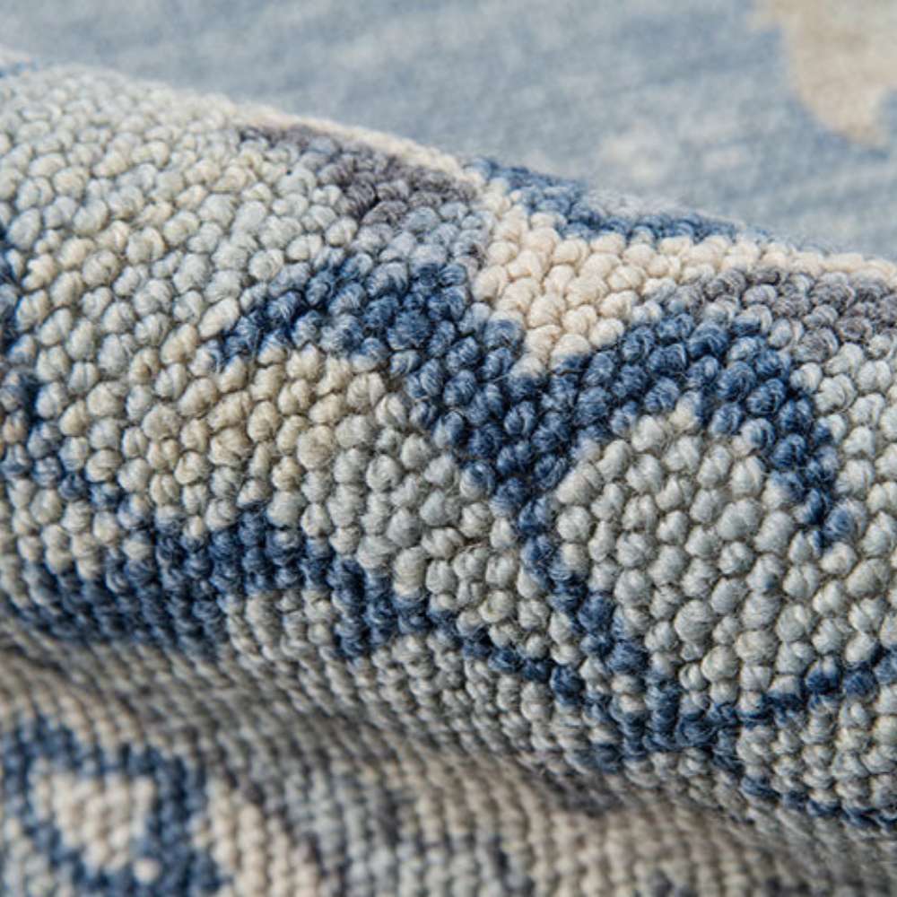 A side view highlights the thick, looped texture of Momeni Anatolia Indoor Rug - ANA-9 Blue, showcasing its durable hand-crafted weave