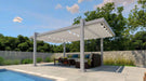 A sleek Structureworks Balance Trex Pergola with a clean white canopy shades a seating area on a stone patio with garden views and a pool nearby