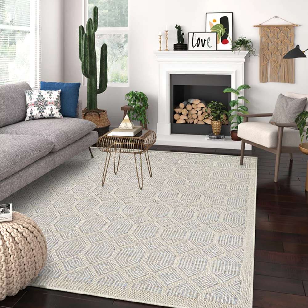 A styled living room shows Couristan Liguria Indoor/Outdoor Rug - Rapallo/Aqua beneath a sofa and coffee table