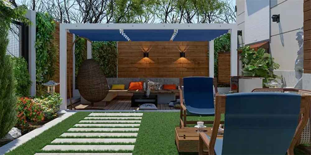 A stylish garden setup includes a white-framed Structureworks Breeze Aluminum Pergola with blue panels above a comfy outdoor sofa and armchairs on a wooden deck