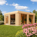 A stylish wooden cube-shaped GardenHouse24 USA Sauna Dolce 70 Garden Room with large glass sliding doors sits in a lush garden