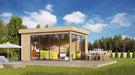 A stylish wooden structure with floor-to-ceiling glass walls stands on a sunny lawn with a dining table outside—this is the GardenHouse24 USA ALU Concept 70A Garden Room