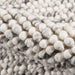 A textured macro shot of Momeni Andes Indoor Rug - AND-8 Ivory revealing its thick, plush wool pile