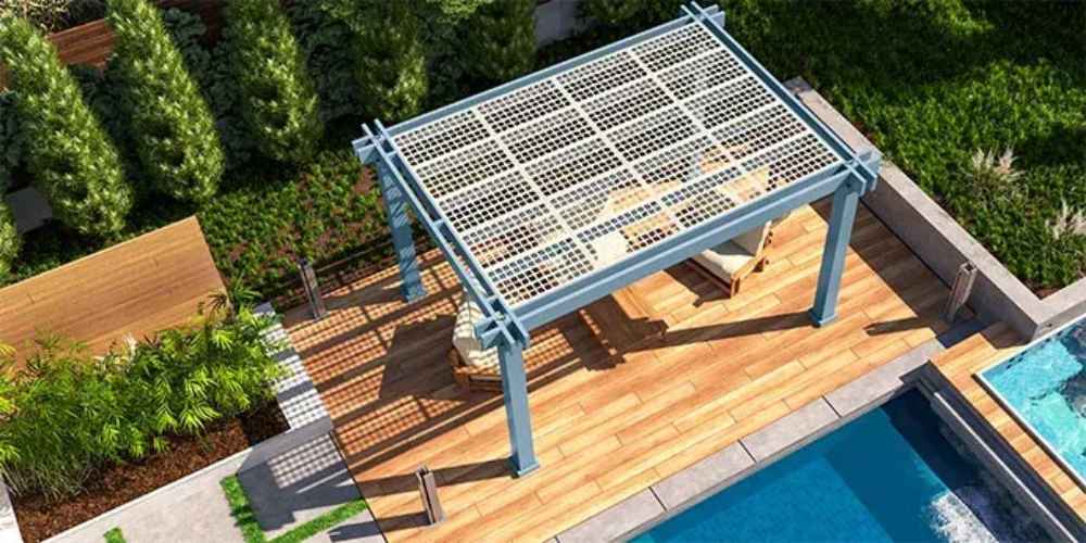 A top-down view shows the Structureworks Reverie Fiberglass Pergola casting shadows over an outdoor lounge area beside a pool