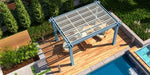 A top-down view shows the Structureworks Reverie Fiberglass Pergola casting shadows over an outdoor lounge area beside a pool
