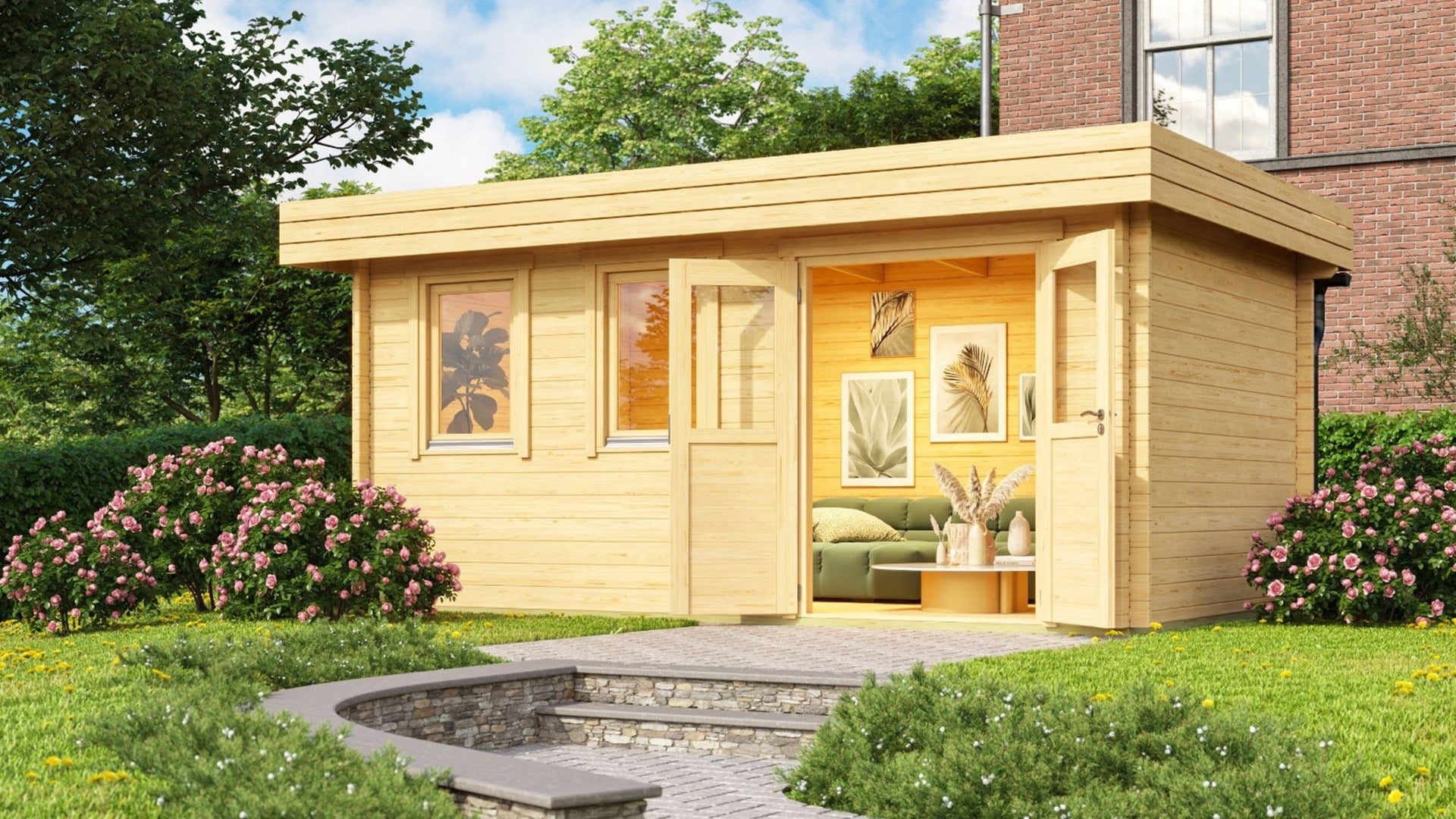 A vibrant garden scene showcases the GardenHouse24 USA Miriam 44B Classic Garden Room with open double doors revealing a cozy interior filled with framed artwork, greenery, and a soft sofa