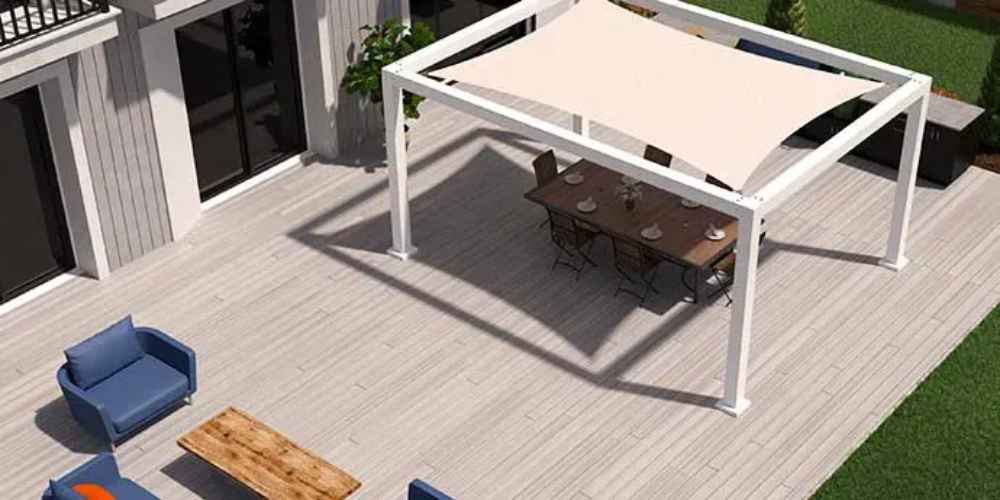 A white Structureworks Solis Trex Pergola covers a spacious dining setup on a large deck next to a house