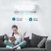 A woman enjoys quiet comfort while reading as the Senville 36000 BTU Mini Split Air Conditioner - Heat Pump - SENL36CD runs silently with remote control in hand