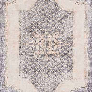 A zoomed-in center detail of Momeni Afshar Indoor Rug - AFS35 Denim reveals the intricate medallion pattern with a distressed finish