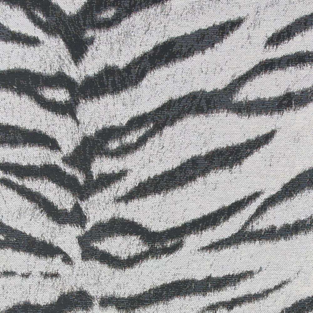 A zoomed-in image of Couristan Dolce Indoor/Outdoor Rug - Bengal/Ivory showcasing its centered black pattern that mimics natural tiger stripes