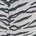 A zoomed-in image of Couristan Dolce Indoor/Outdoor Rug - Bengal/Ivory showcasing its centered black pattern that mimics natural tiger stripes