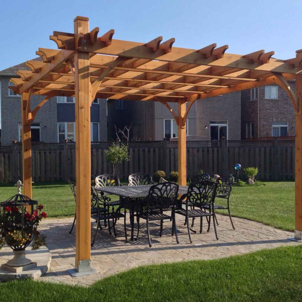 A backyard setting showing the Outdoor Living Today Western Red Cedar Pergola & Canopy placed over an elegant outdoor dining set