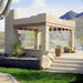 A beige outdoor gazebo surrounded by plants uses the Aeromist Pinnacle 1000 PSI Misting System to release a fine mist from the roof edges