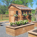 A charming backyard features raised garden beds and the Outdoor Living Today 8×8 Sunshed Garden Shed
