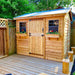 A charming wooden shed with flower boxes and a corrugated metal roof stands on a deck, showcasing the Outdoor Living Today 9×6 Cabana Garden Shed