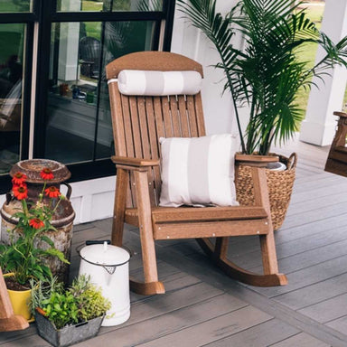 A classic wooden rocking chair on a porch is complemented by a striped LuxCraft Neck Pillow