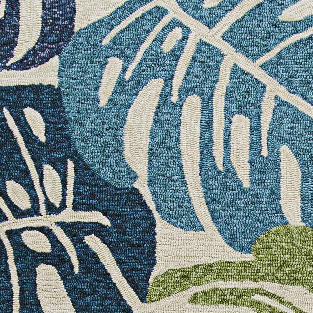 A close-up detail of the Couristan Covington Indoor/Outdoor Rug - Monstera/Cream-Multi shows tightly looped fibers and crisp leaf outlines