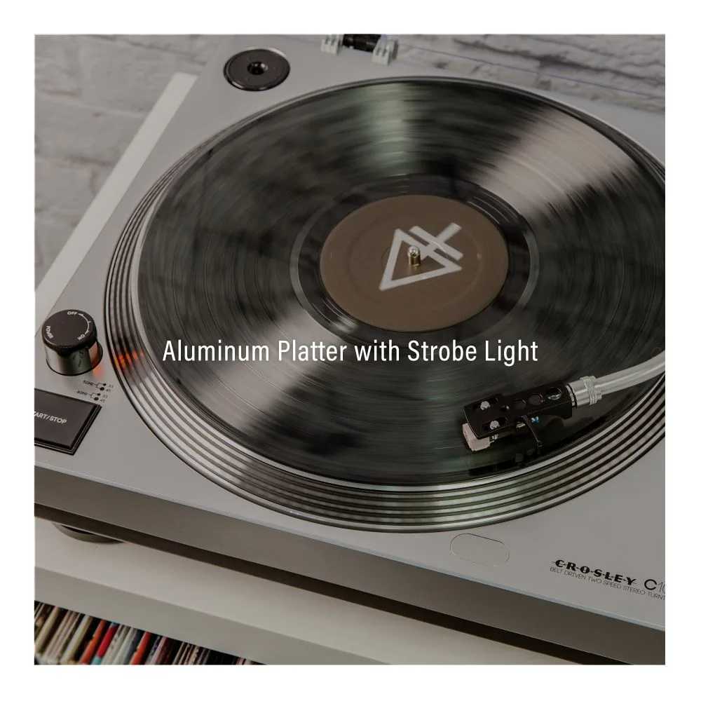 A close-up image of the Crosley C100 Turntable - Silver highlights its aluminum platter with a strobe light