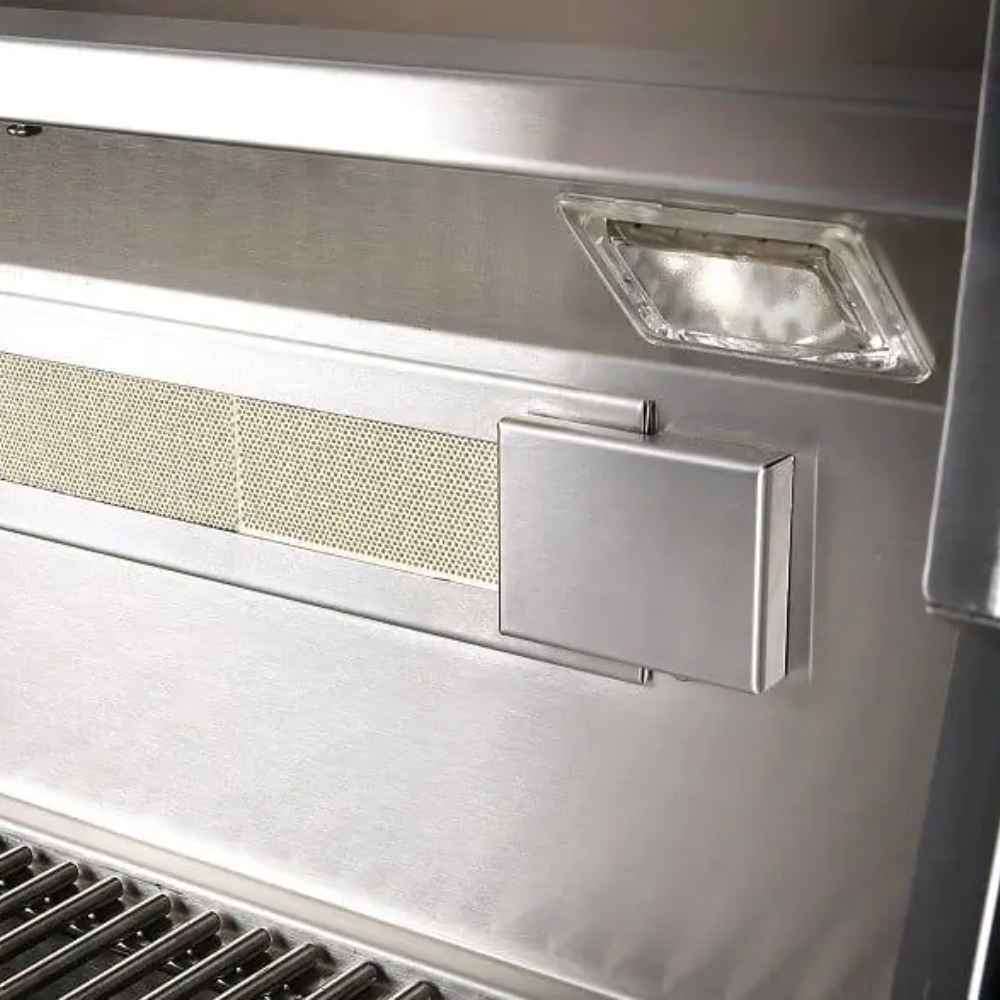 A close-up of the Alfresco Grills Artisan Professional 32” Built-In Grill, 3 Burner shows an interior halogen light