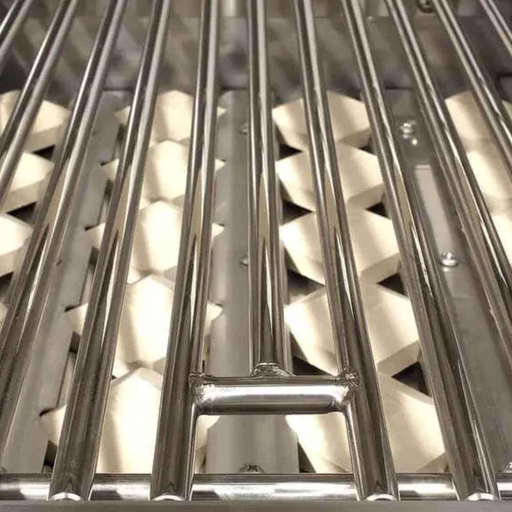 A close-up of the Alfresco Grills Artisan Professional 42” Built-In Grill, 3 Burner shows stainless steel grates and ceramic briquettes