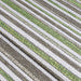 A close-up of the Couristan Cape Indoor/Outdoor Rug - Brockton/Hunter Green-Brown reveals textured stripes in green, brown, and ivory