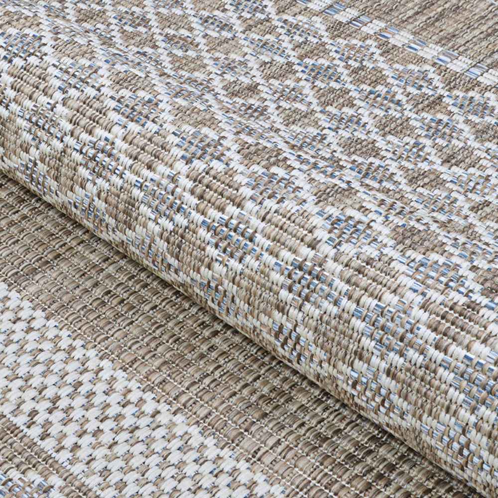 A close-up of the Couristan Charm Indoor/Outdoor Rug - Yukon/Twig reveals its thick, woven texture in earth-toned threads