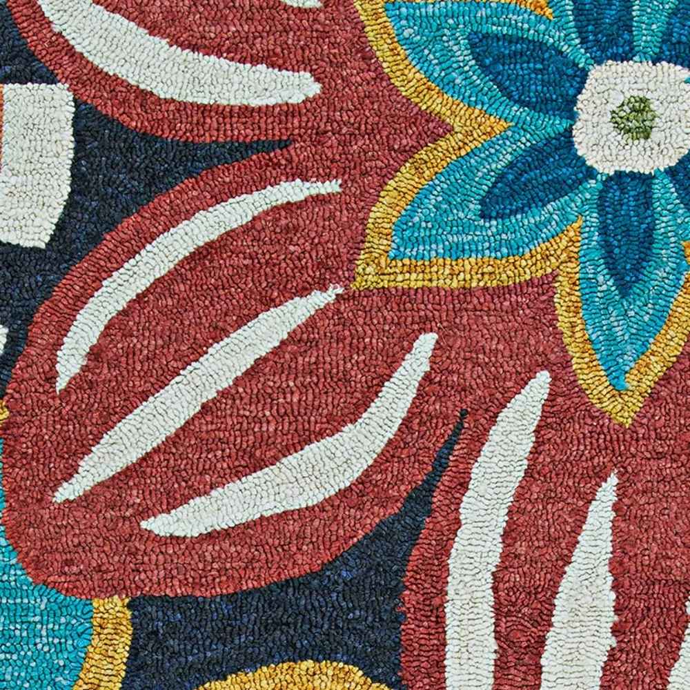 A close-up of the Couristan Covington Indoor/Outdoor Rug - Geranium/Navy-Multi reveals textured loops and clean color contrasts between flowers