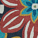 A close-up of the Couristan Covington Indoor/Outdoor Rug - Geranium/Navy-Multi reveals textured loops and clean color contrasts between flowers