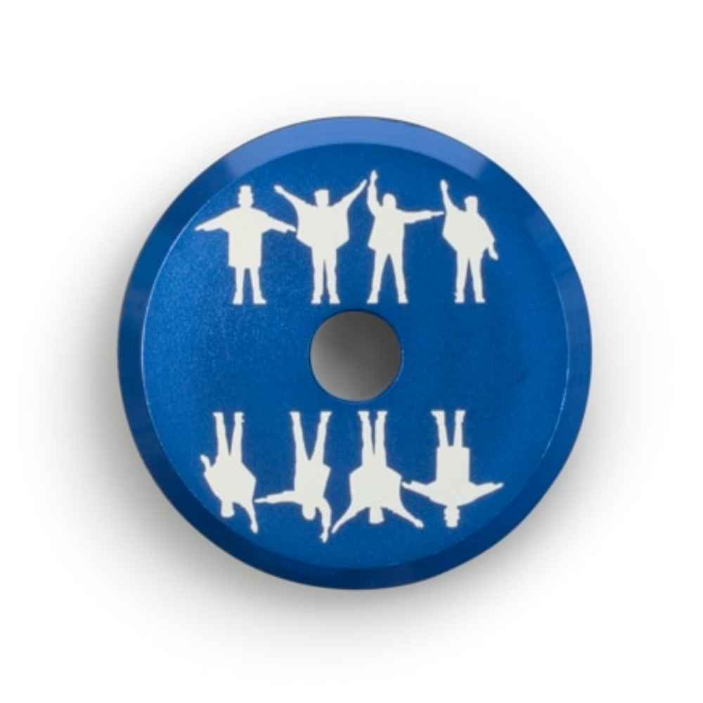 A close-up of the Crosley The BEATLES 45 Adapter - HELP, highlighting the blue surface and detailed Beatles silhouettes