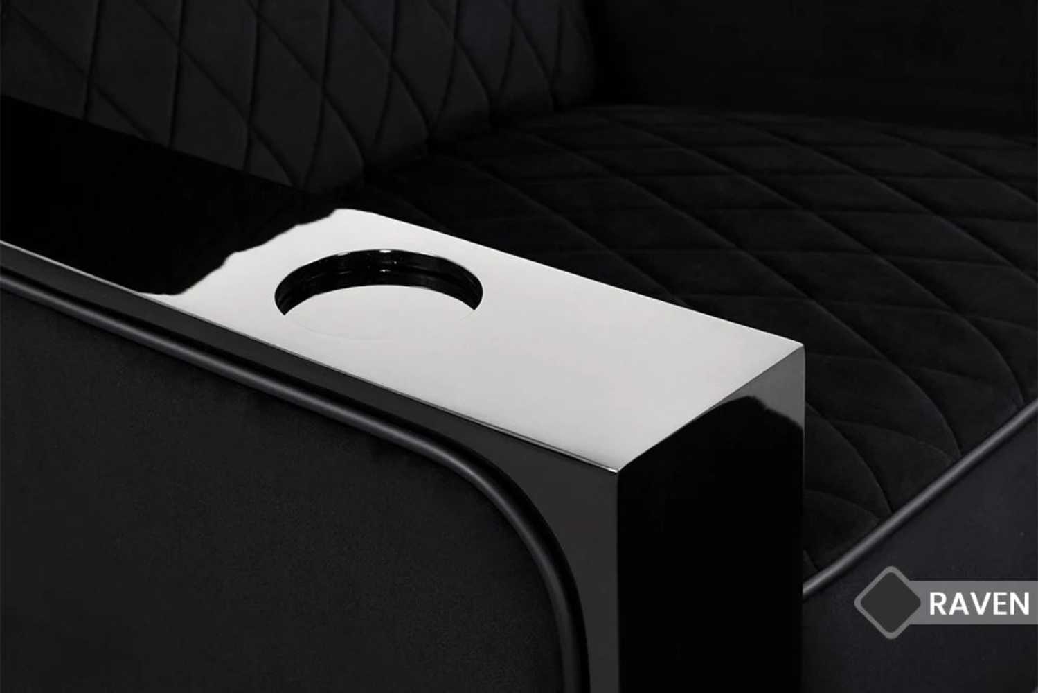 A close-up of the Valencia Naples Prestige Home Theater Seating shows a carved cup holder elegantly embedded into its piano wood armrest