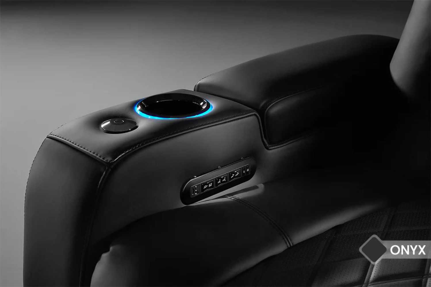 A close-up of the Valencia Tuscany Slim Ultimate Edition Home Theater Seating cup holder with illuminated RGB lighting