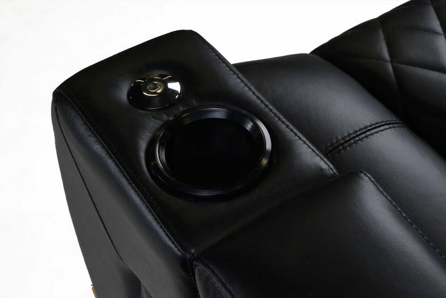 A close-up of the armrest of the midnight black Valencia Tuscany XL Console Edition Home Theater Seating highlights the cupholder and control buttons