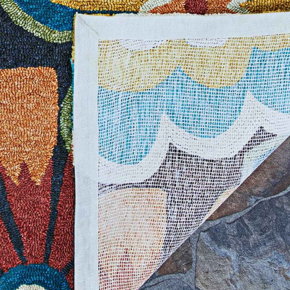A close-up of the backing shows the durable mesh and thick stitching of the Couristan Covington Indoor/Outdoor Rug - Geranium/Navy-Multi