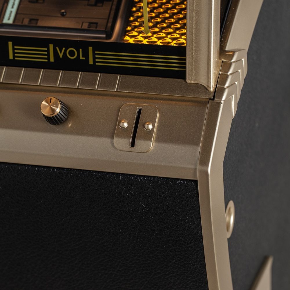 A close-up of the coin slot on the Marshall Rocket CD Jukebox - Black shows a vintage-style slot for manual operation