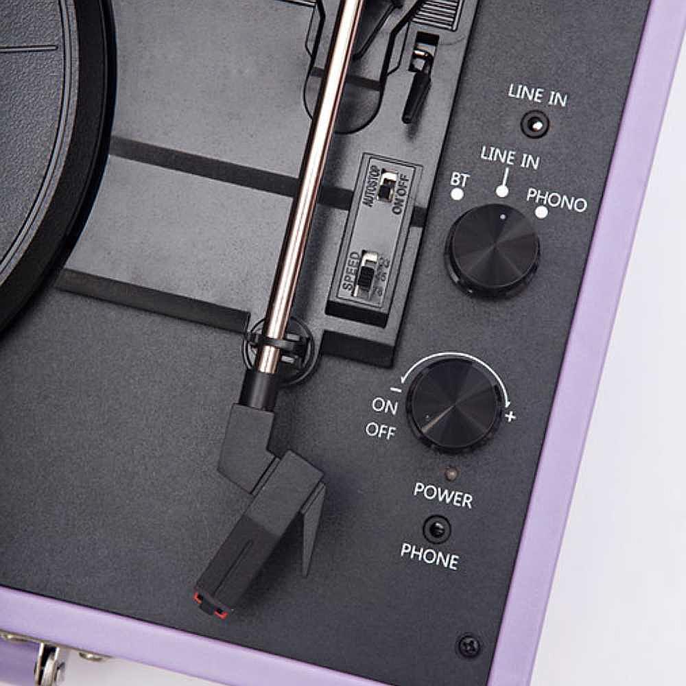 A close-up of the control panel on the Arkrocket Curiosity Suitcase Bluetooth Turntable (Lavender) shows the speed switch, power button, and audio inputs