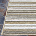 A close-up of the corner of the Couristan Cape Indoor/Outdoor Rug - Brockton/Light Brown-Ivory placed on stone flooring