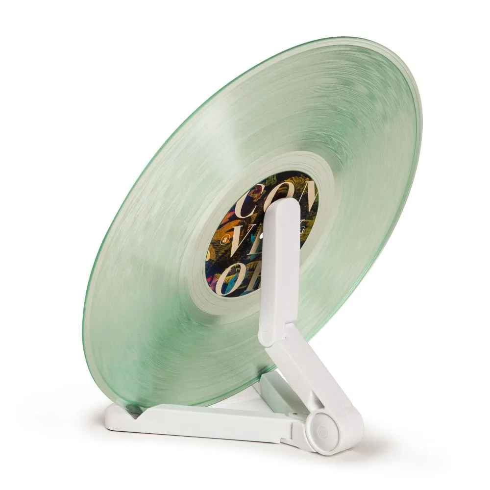 A close-up of the folding stand from the Crosley 5-in-1 Record Cleaning Kit supporting a green vinyl record