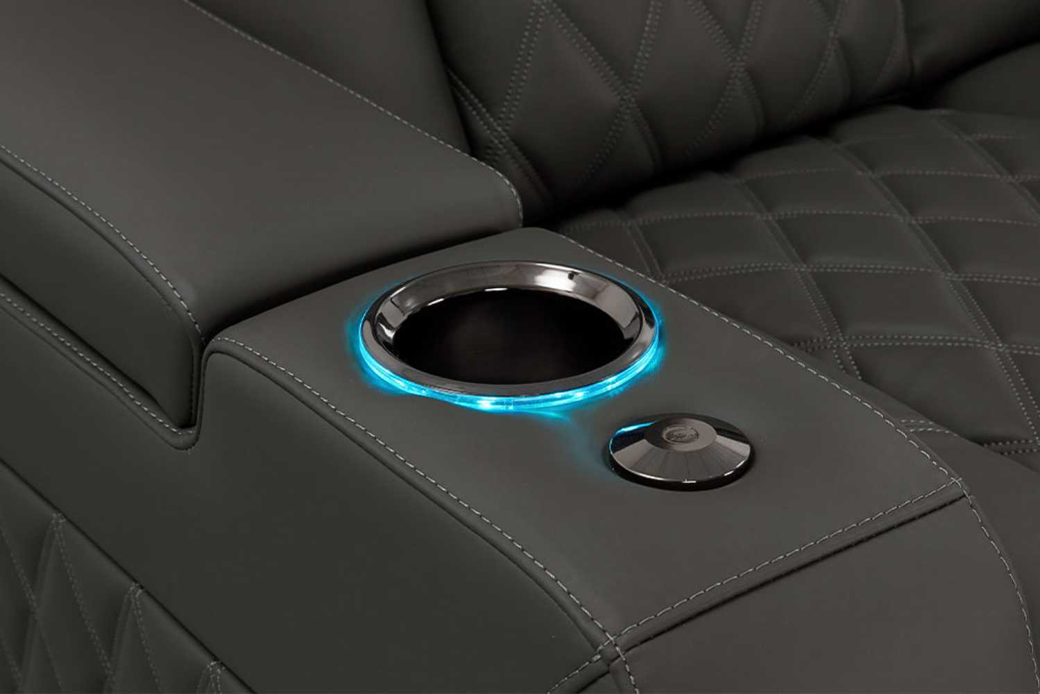 A close-up of the illuminated cup holder on the graphite Valencia Tuscany Luxury Edition Home Theater Seating