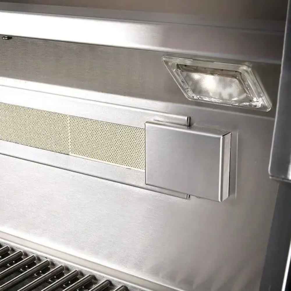 A close-up of the interior lighting and stainless steel walls of the Alfresco Grills Artisan Professional 32” Cart Grill, 3 Burner