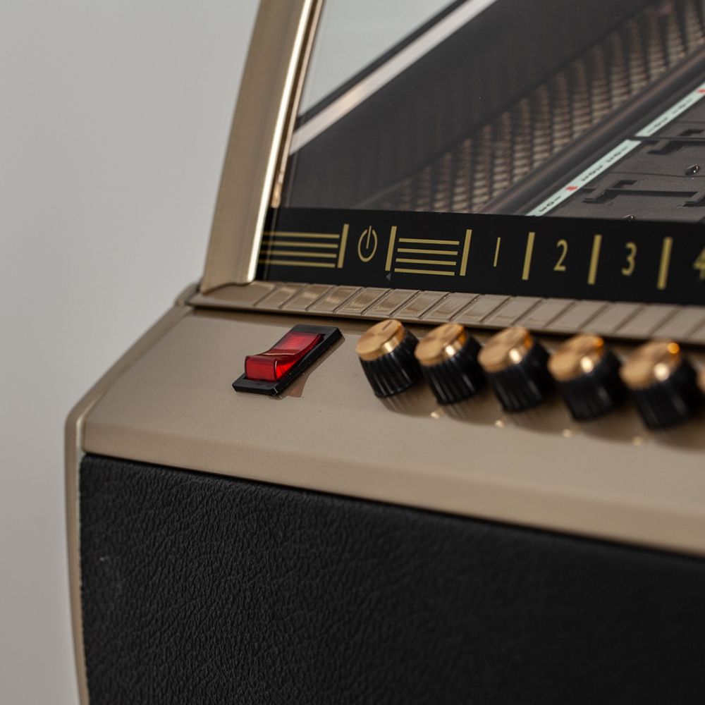 A close-up of the red power switch on the Marshall Rocket CD Jukebox - Black highlights its easy-to-use interface