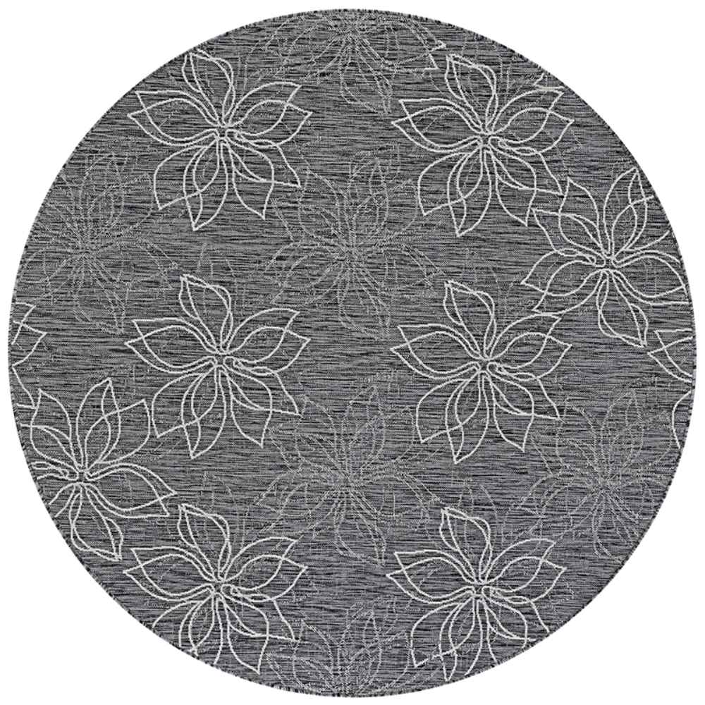 A close-up of the round Couristan Charm Indoor/Outdoor Rug - Botanical/Ash shows a floral pattern with white outlined petals on a textured ash background