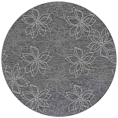 A close-up of the round Couristan Charm Indoor/Outdoor Rug - Botanical/Ash shows a floral pattern with white outlined petals on a textured ash background