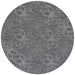 A close-up of the round Couristan Charm Indoor/Outdoor Rug - Botanical/Ash shows a floral pattern with white outlined petals on a textured ash background