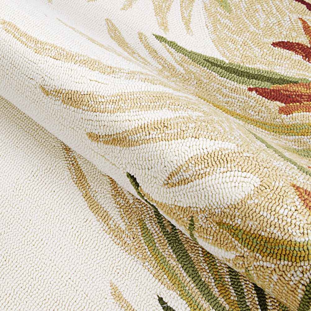 A close-up of the rug shows its looped texture and tropical colors, part of the Couristan Covington Indoor/Outdoor Rug - Tropics Garden/Sand-Multi