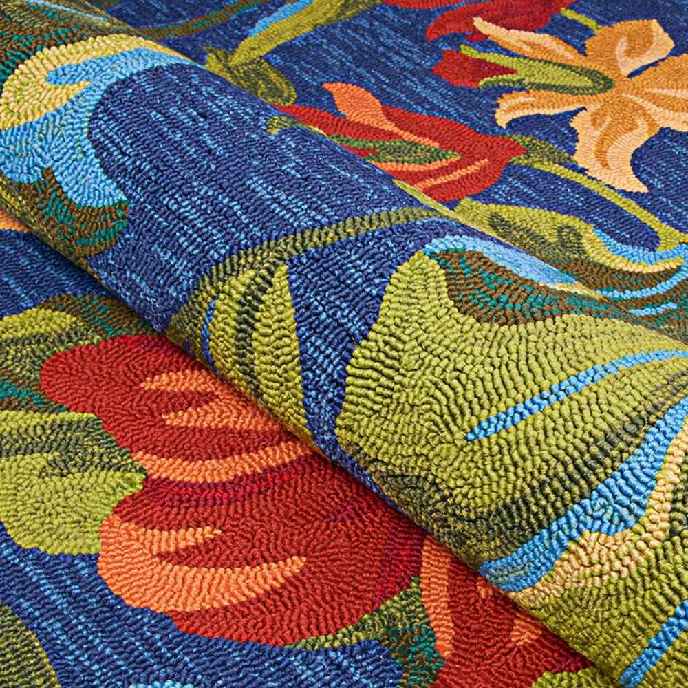 A close-up showcases the textured loops of the Couristan Covington Indoor/Outdoor Rug - Tropical Orchid/Azure-Forest Green-Red
