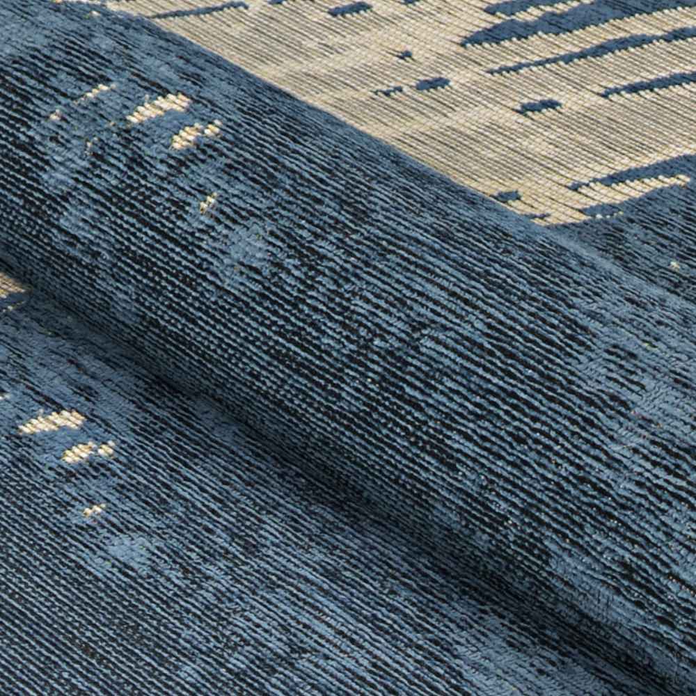 A close-up shows the Couristan Castille Indoor/Outdoor Rug - Canvas/Orion rolled up