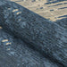 A close-up shows the Couristan Castille Indoor/Outdoor Rug - Canvas/Orion rolled up