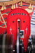 A close-up shows the Crosley Slimline Bluetooth Full-Size Jukebox's red internal mechanism that plays records