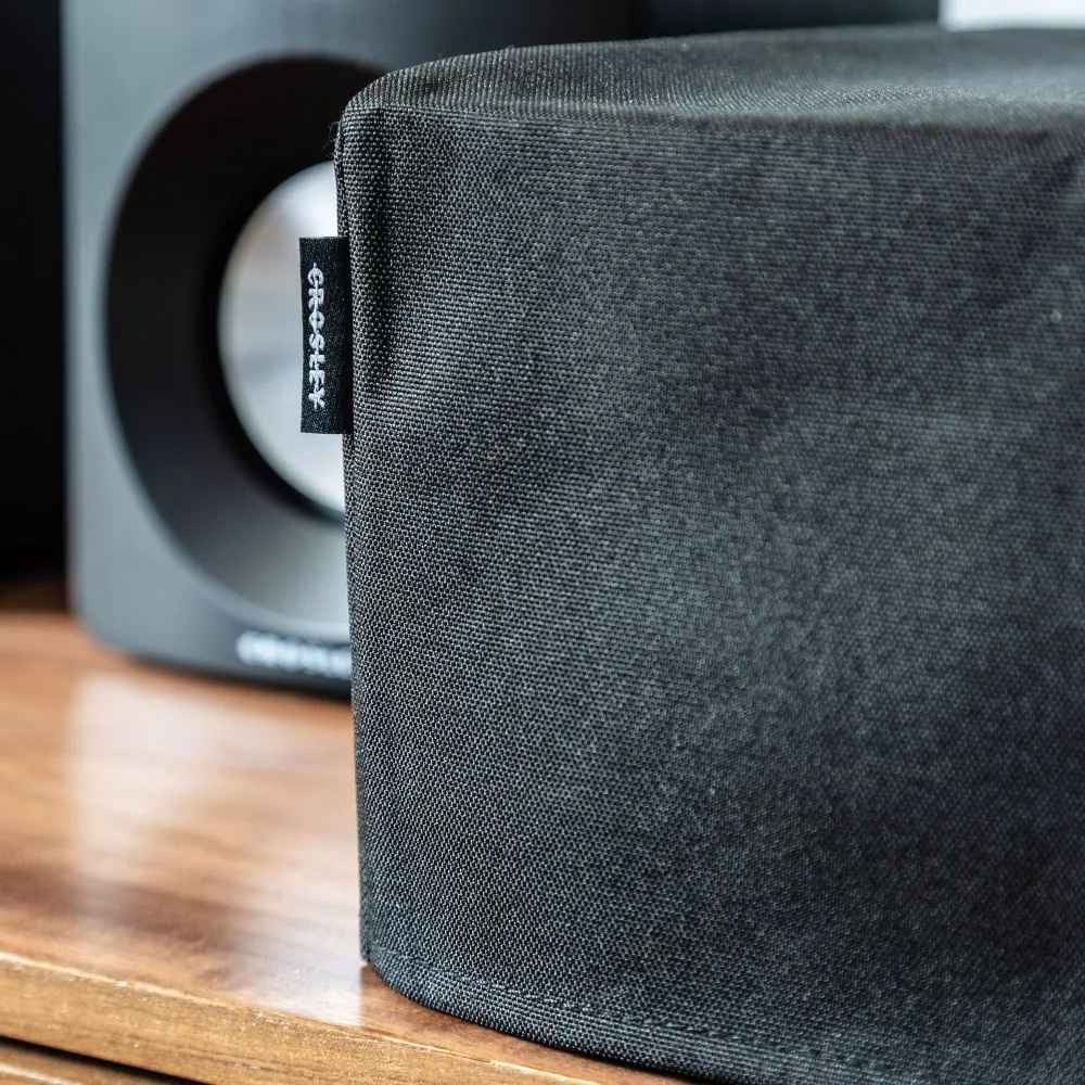 A close-up shows the corner stitching of the Crosley Fabric Turntable Dust Cover - Black with its Crosley logo tag visible