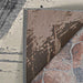 A close-up shows the layered textures and backing details of the Couristan Castille Indoor/Outdoor Rug - Canvas/Glacier